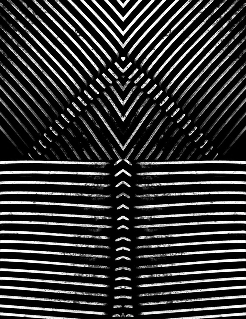Black-and-white abstract photograph showing a symmetrical pattern of diagonal and horizontal metal slats, creating an optical illusion through repeating lines and mirrored geometry.